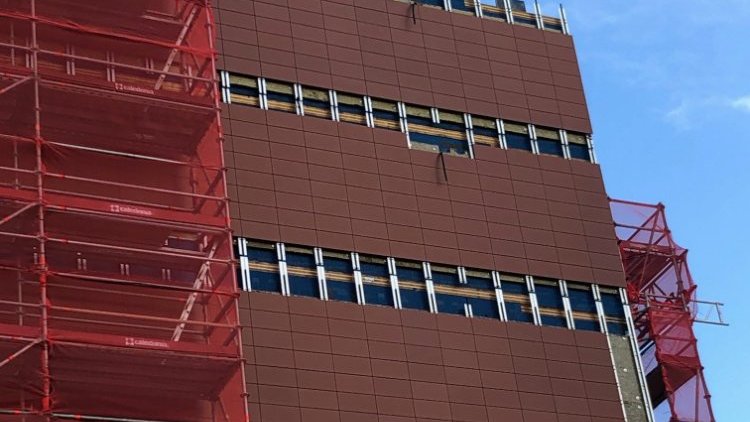 HomeGround Building  - Building exterior with construction scaffolds and protective net